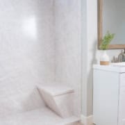 Side view of modern bathroom with shower bench